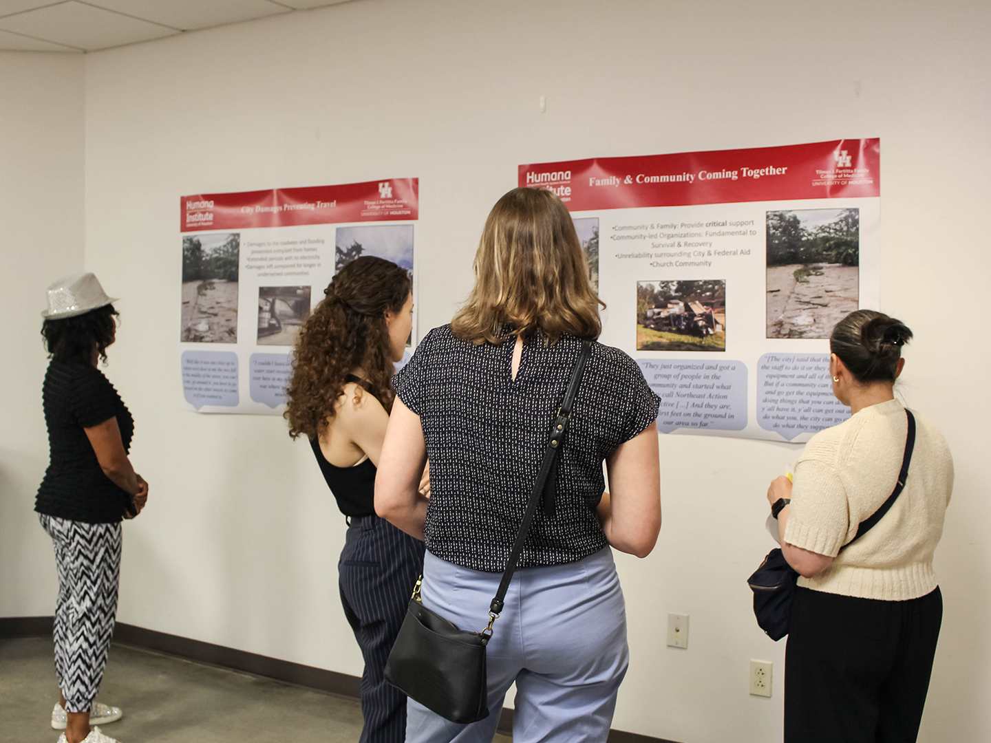 people looking at flood victim's story posters