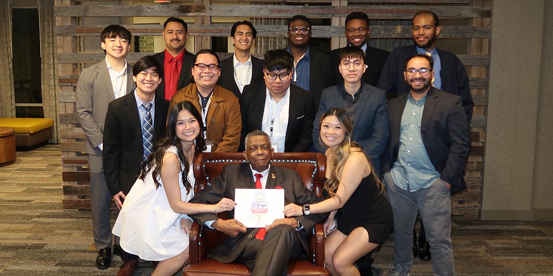 kappa psi chapter members and advisor williams with plaque